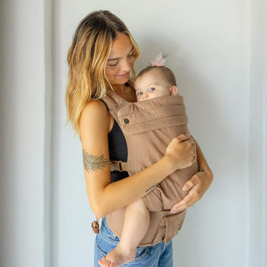 Woman holding a baby in Monroe x Coco Desert - Cotton Linen Baby Carrier