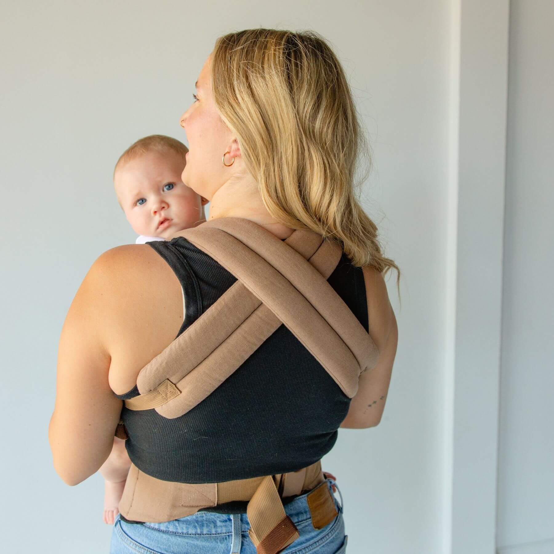 Woman wearing a baby in Monroe x Coco Desert - Cotton Linen Baby Carrier