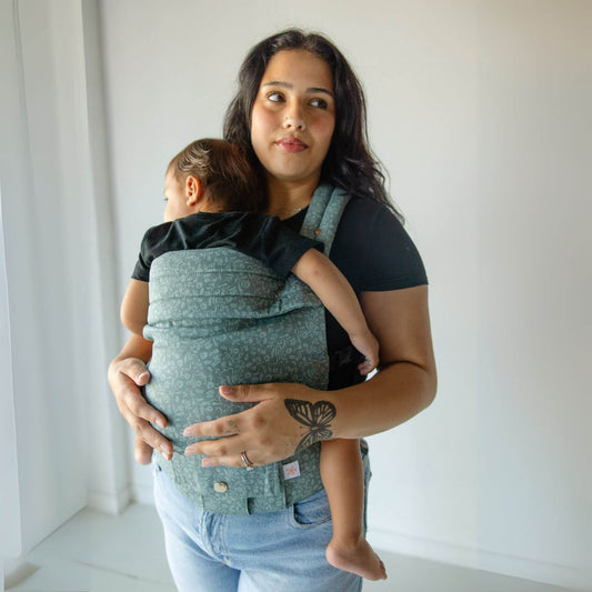 Woman holding a baby in Monroe x Coco Bloom – Neutral Cotton Baby Carrier