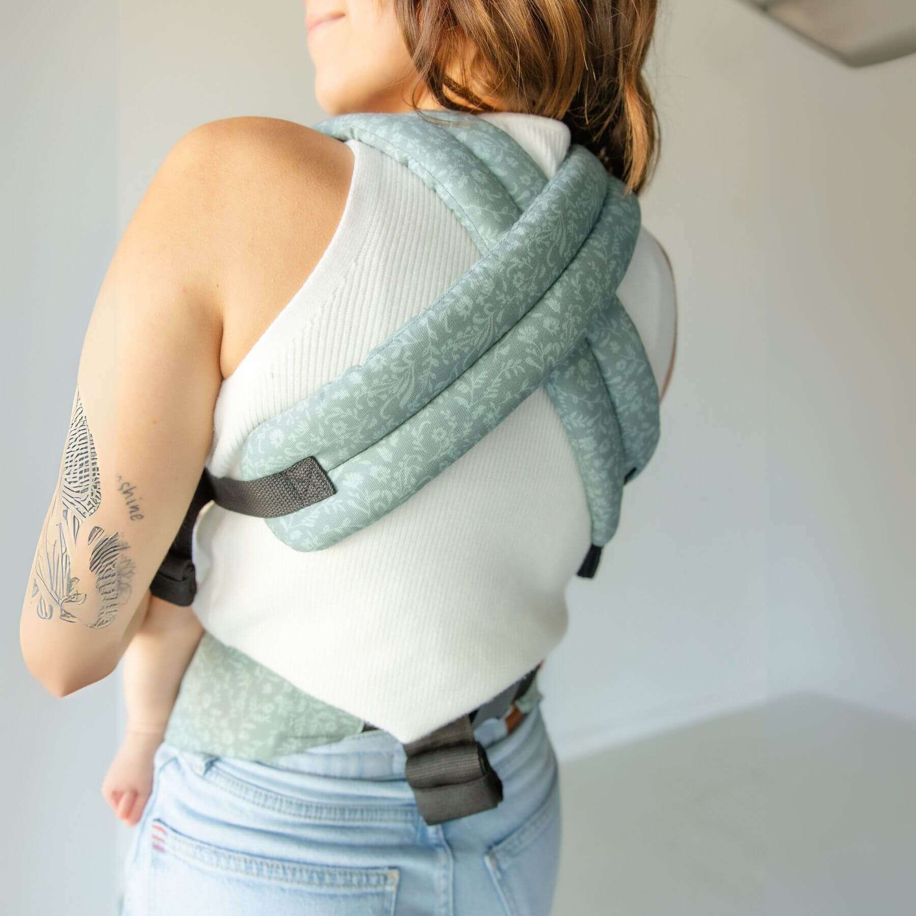 Person wearing Monroe x Coco Bloom – Neutral Cotton Baby Carrier