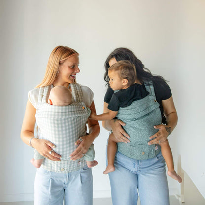 Two women holding babies in Monroe x Coco Bloom – Neutral Cotton Baby Carrier
