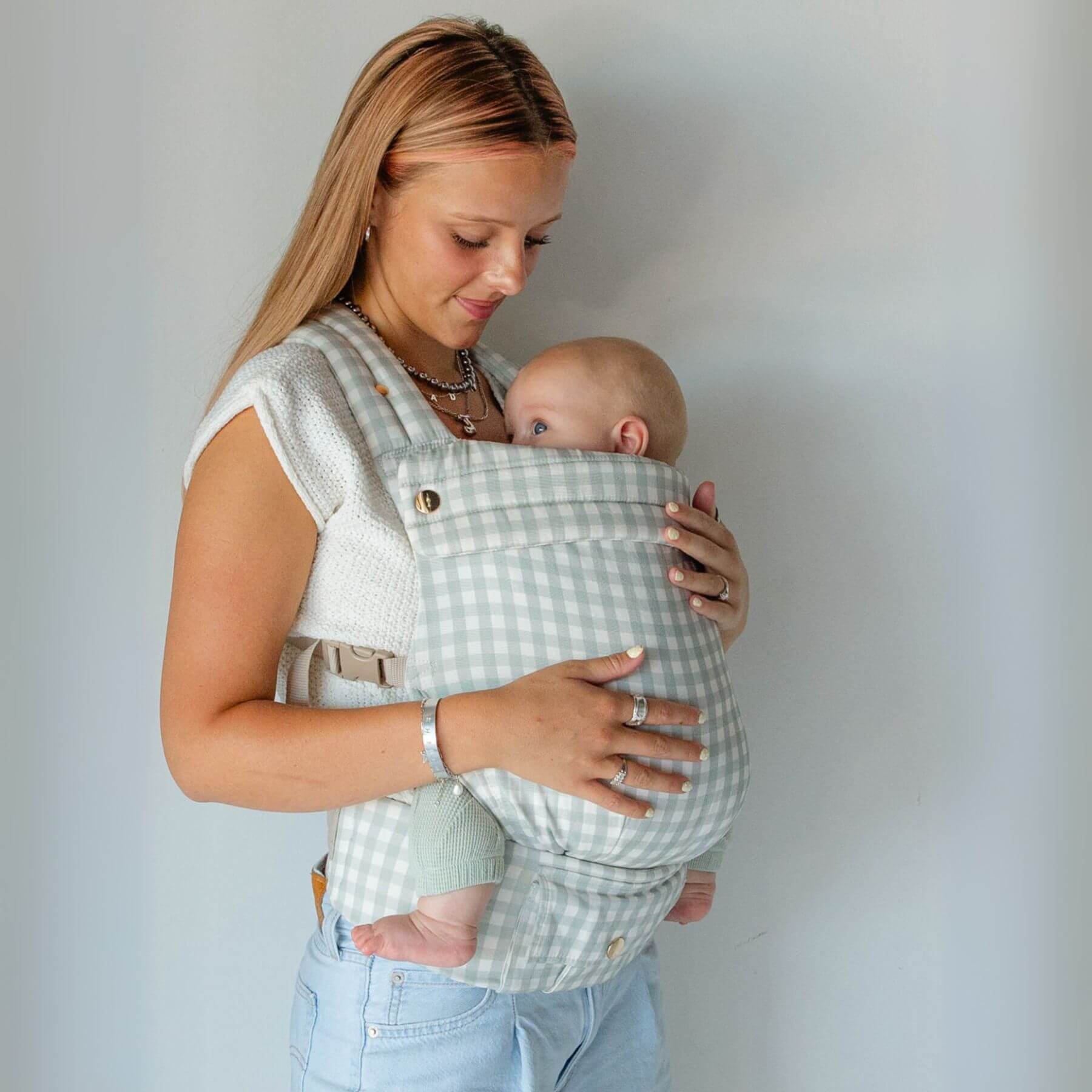 Woman holding a baby in Monroe x Coco Gingham - Cotton Baby Carrier