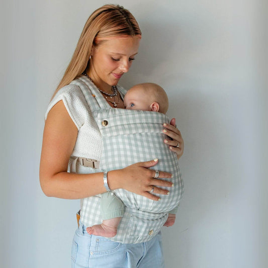 Woman holding a baby in Monroe x Coco Gingham - Cotton Baby Carrier