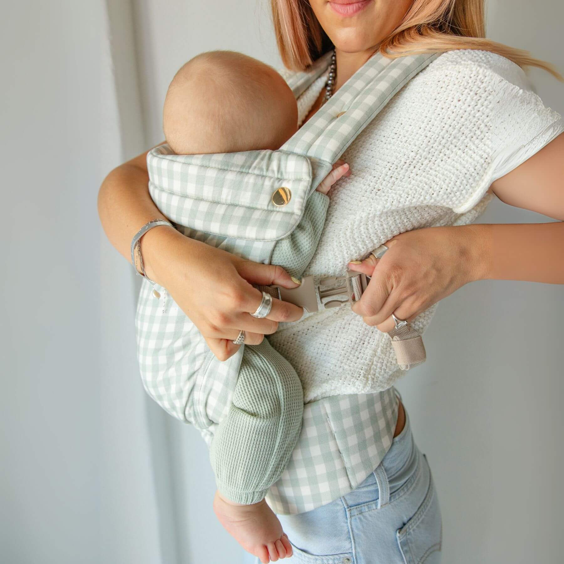 Woman holding a baby in Monroe x Coco Gingham - Cotton Baby Carrier