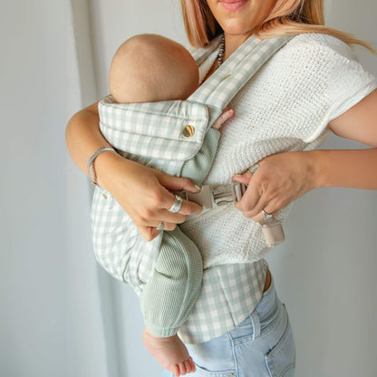 Woman holding a baby in Monroe x Coco Gingham - Cotton Baby Carrier