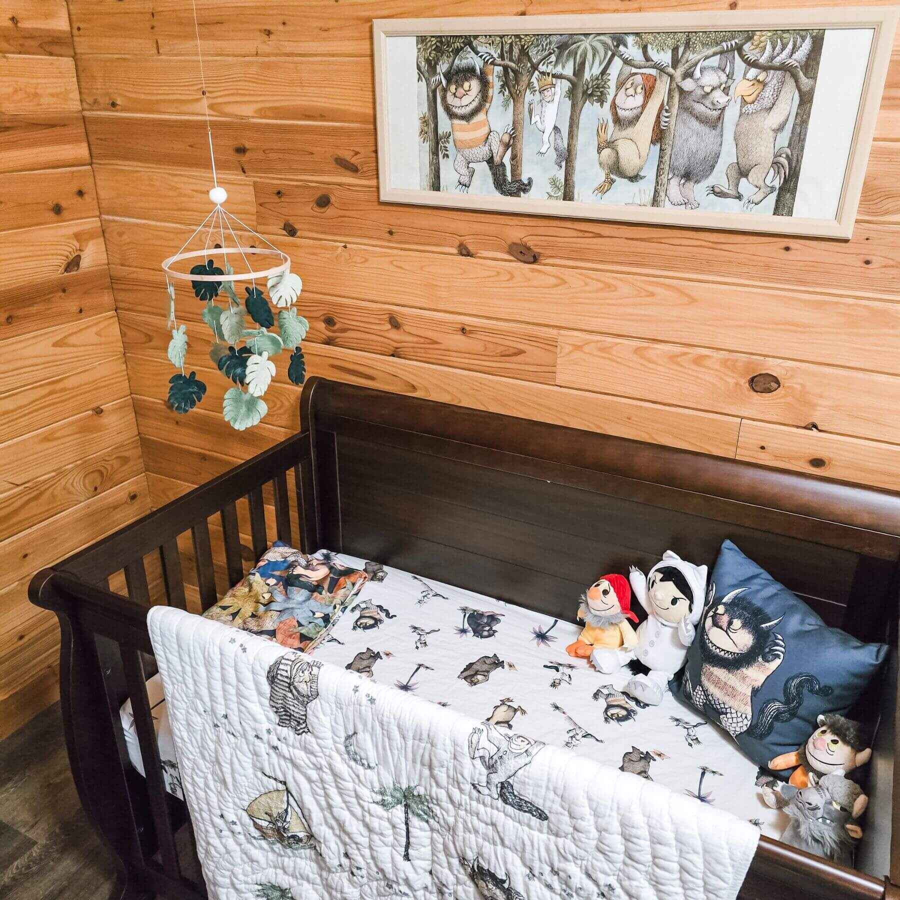 Children's room with wooden walls, crib, and decorative elements.