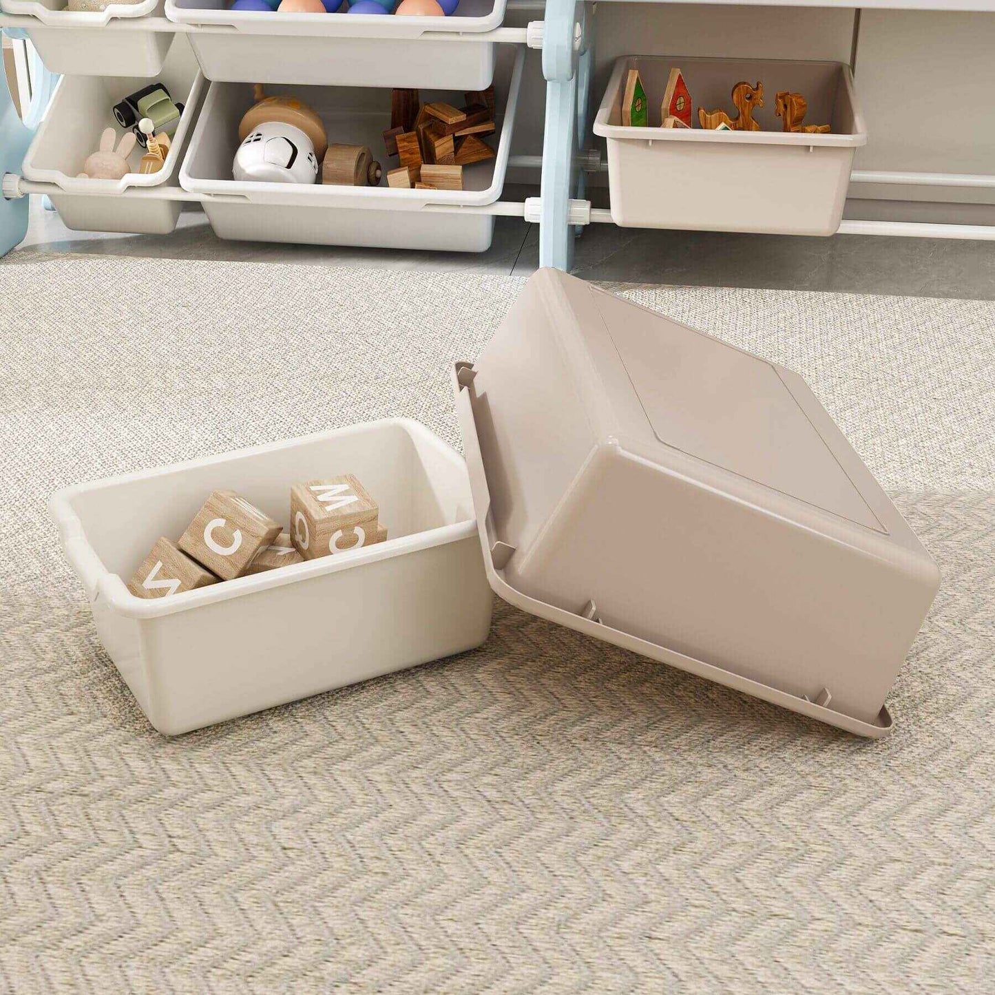 Beige storage bin with a lid open, revealing wooden blocks inside, on a patterned carpet.