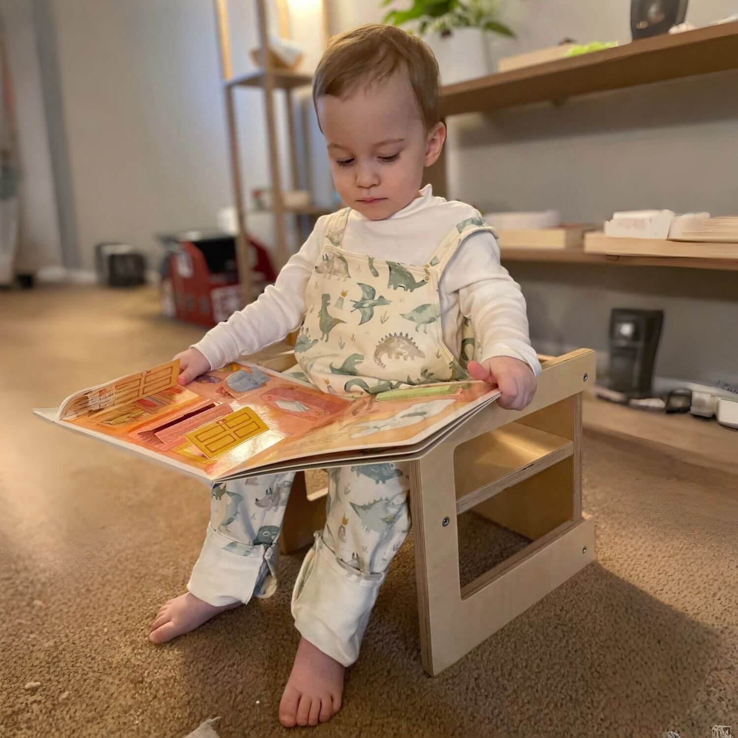 Kid Sitting on RAD Children's Furniture Montessori Cube Chair, Reading