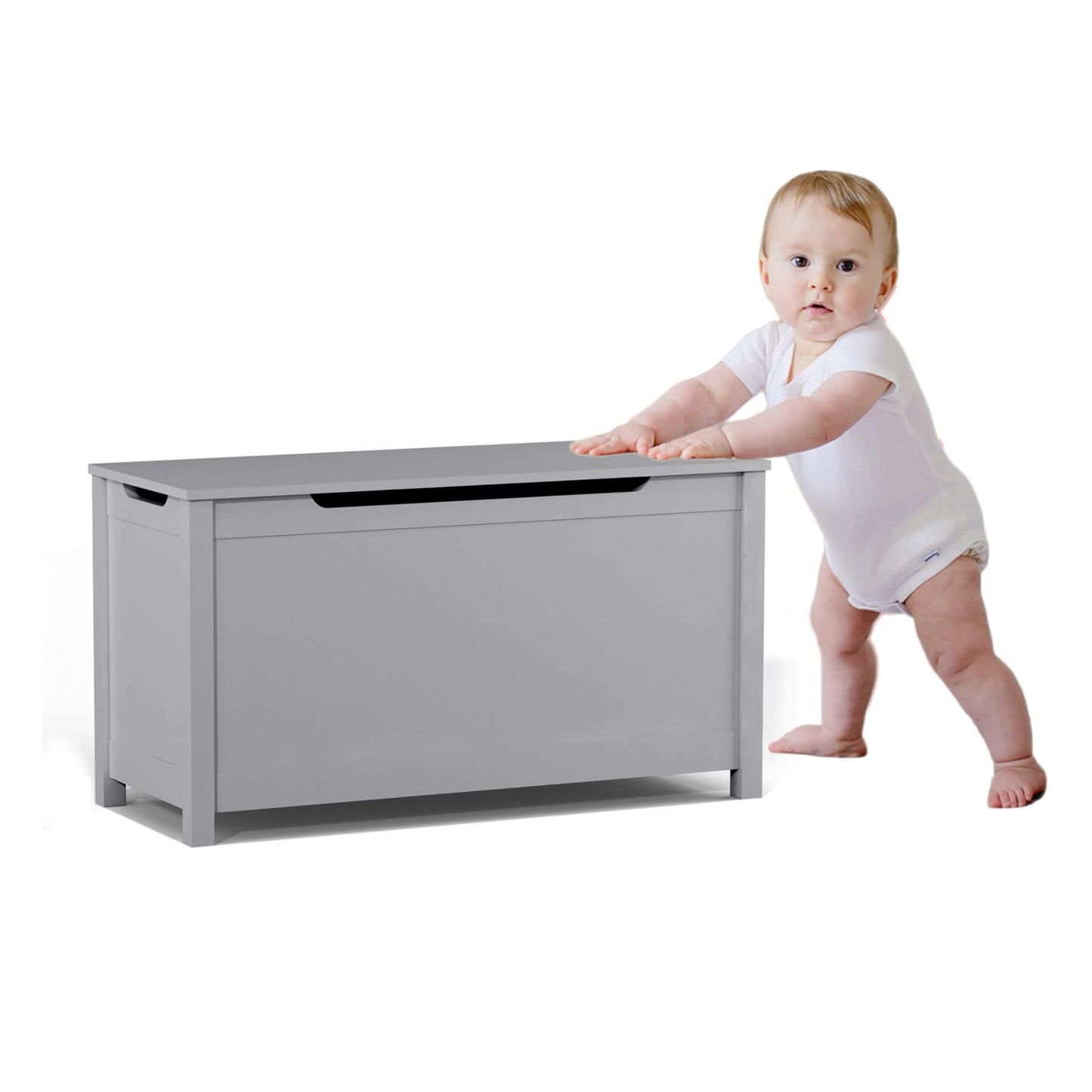 Baby in a white onesie standing next to MOONRIVER Kids Wooden Toy Box Storage with Safety Hinged Lid - Grey