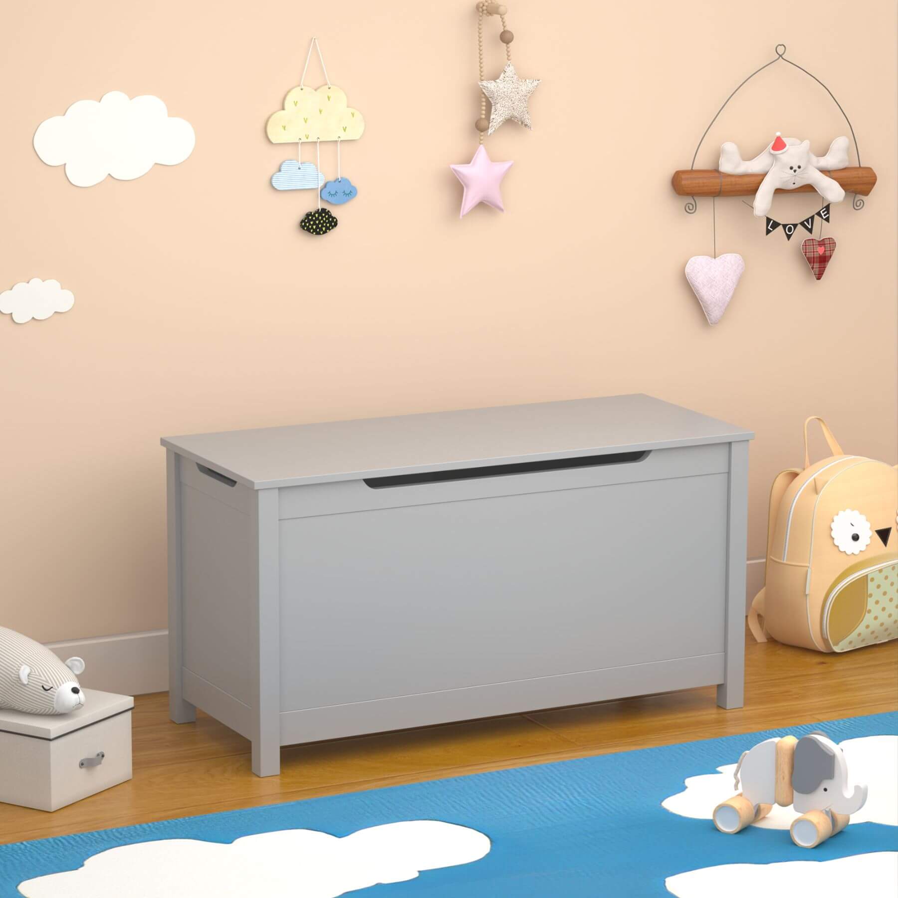 MOONRIVER Kids Wooden Toy Box Storage with Safety Hinged Lid - Grey in a child's room with toys and decorations on the wall.