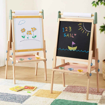 Double-sided children's easel with whiteboard and blackboard, featuring drawings and writings on a wooden floor.
