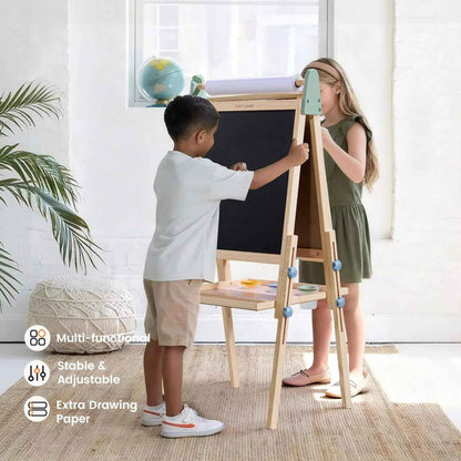 Two children using a multi-functional adjustable easel in a bright room.