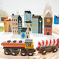 Wooden toy train set with colorful buildings in the background