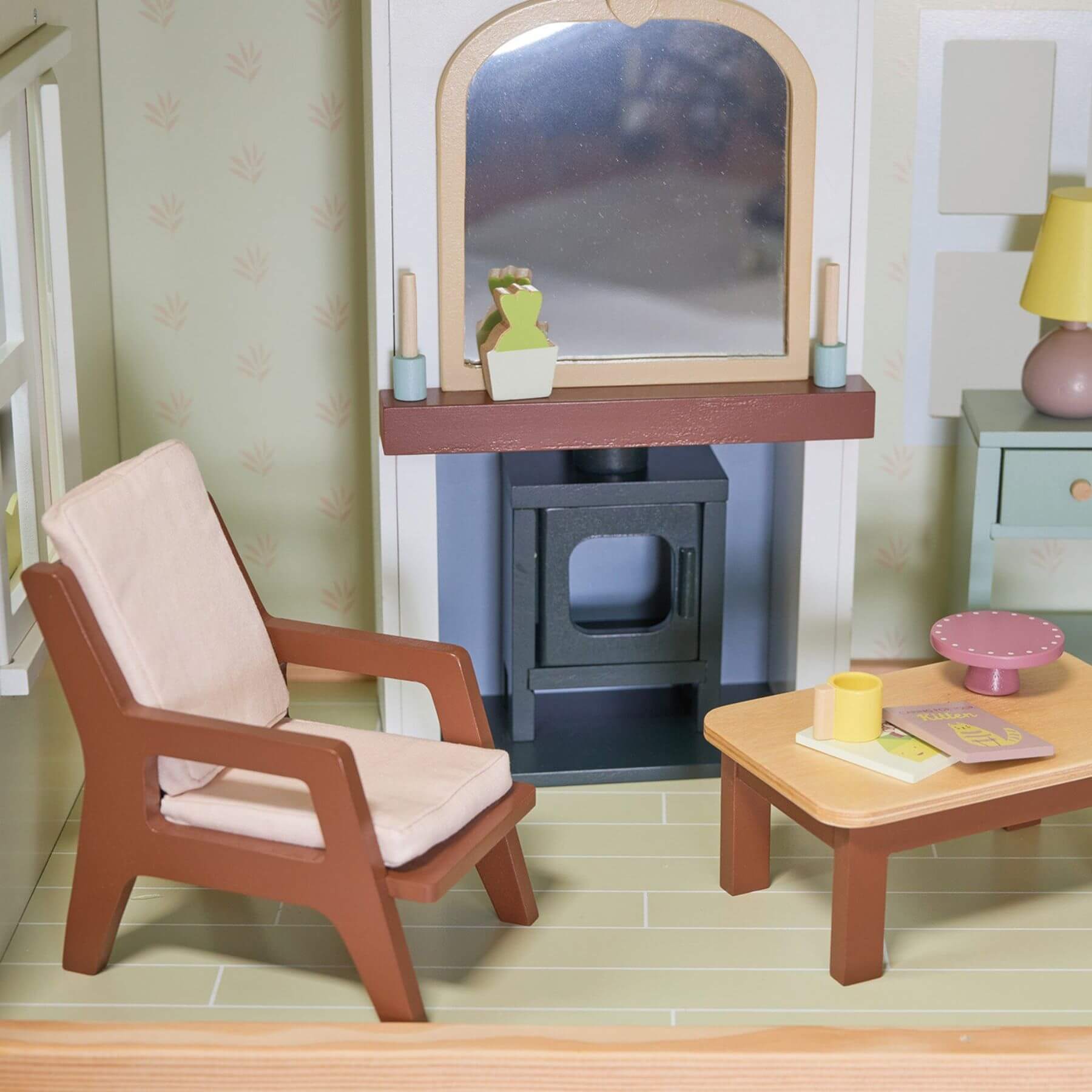 Miniature living room setup with armchair, coffee table, and fireplace.