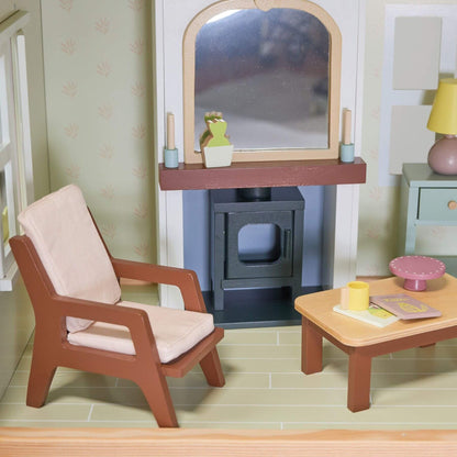 Miniature living room setup with armchair, coffee table, and fireplace.