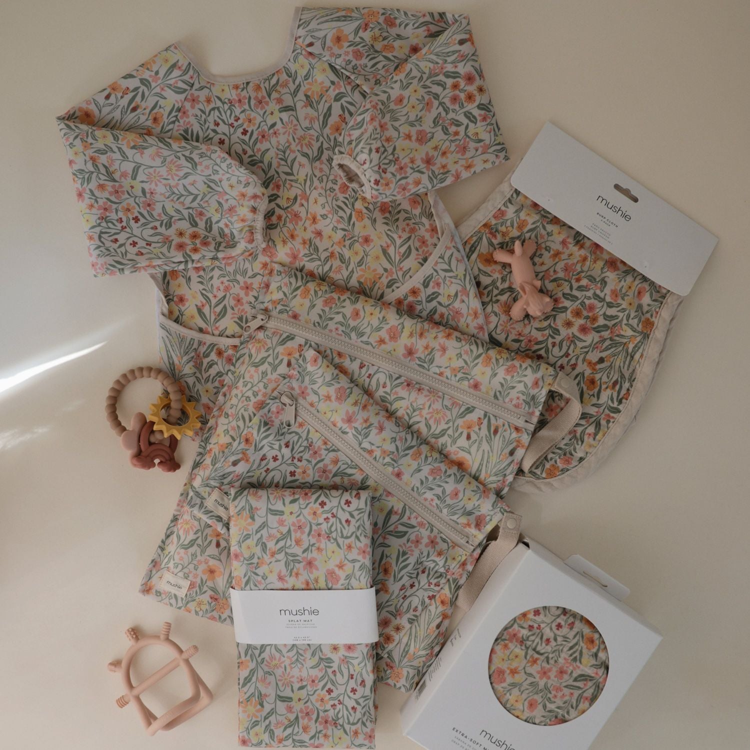 Floral-patterned baby outfit with accessories on a light background
