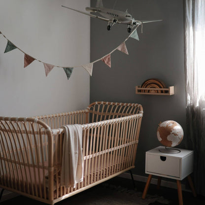 Mushie Organic Cotton Baby Garland above Crib