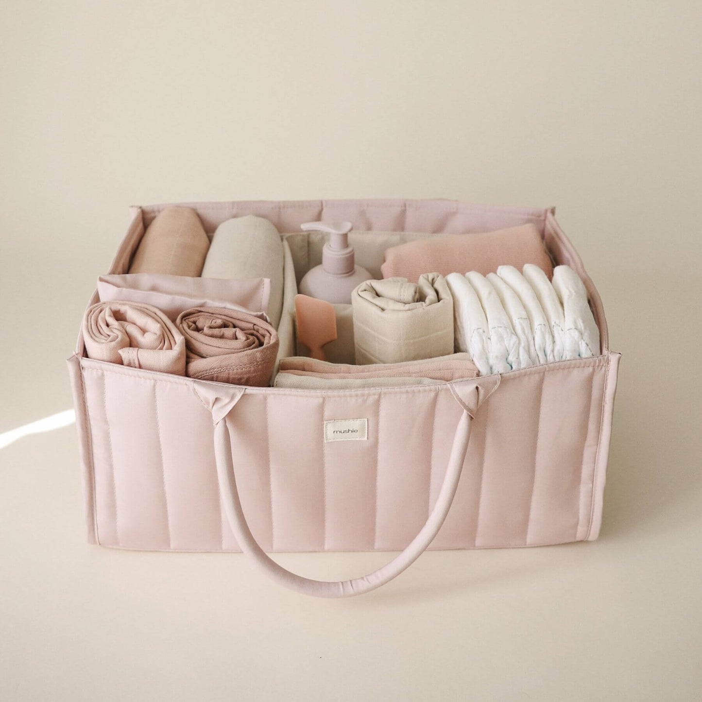 Mushie Diaper Caddy with baby items