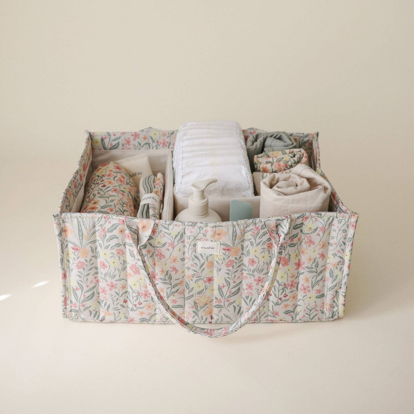 Mushie Diaper Caddy with baby items