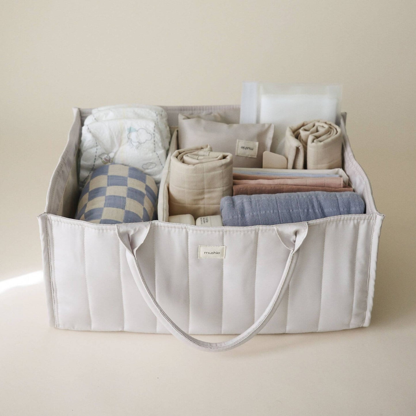 Mushie Diaper Caddy with baby items