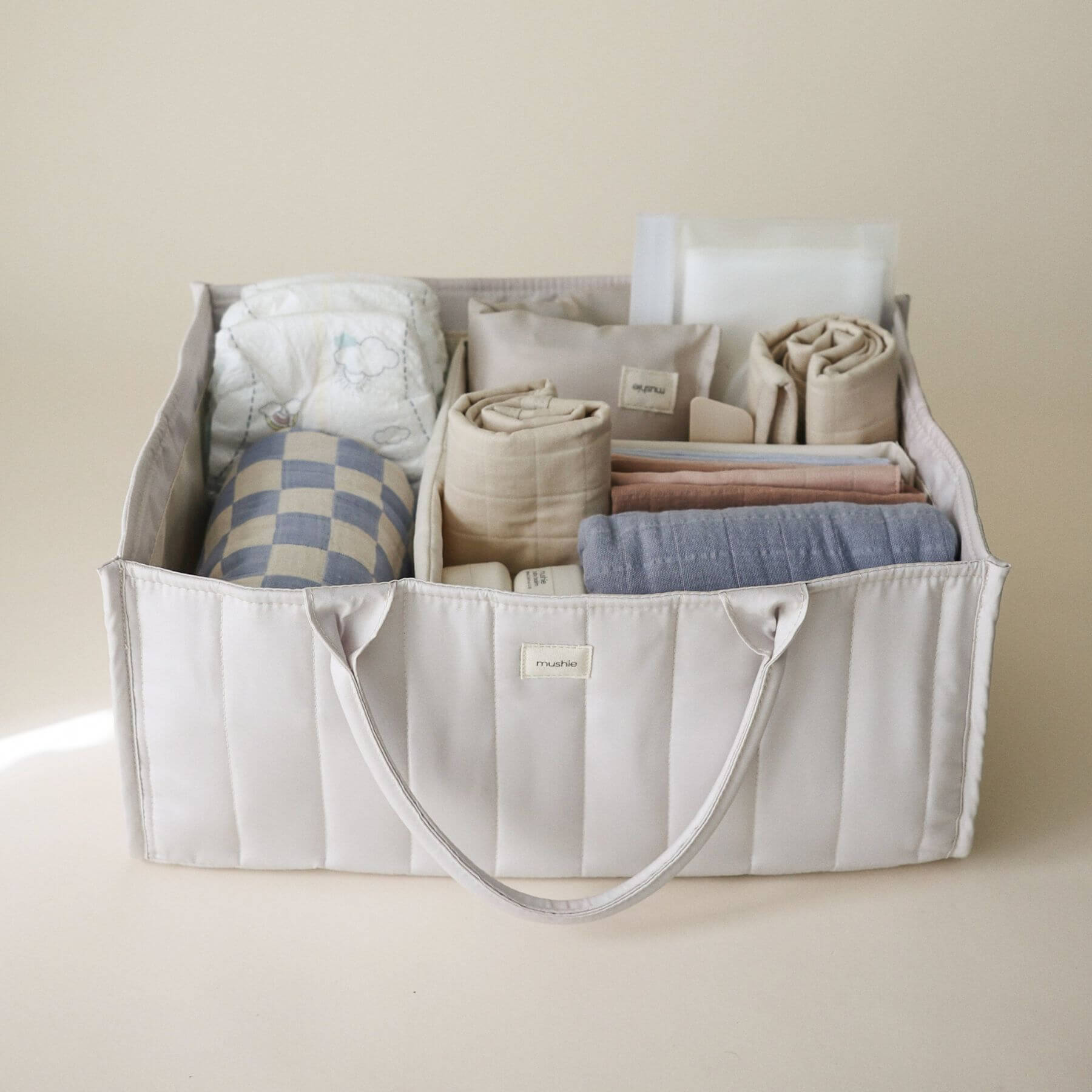 Mushie Diaper Caddy with baby items