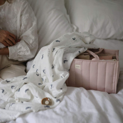 Mushie Diaper Caddy on a bed