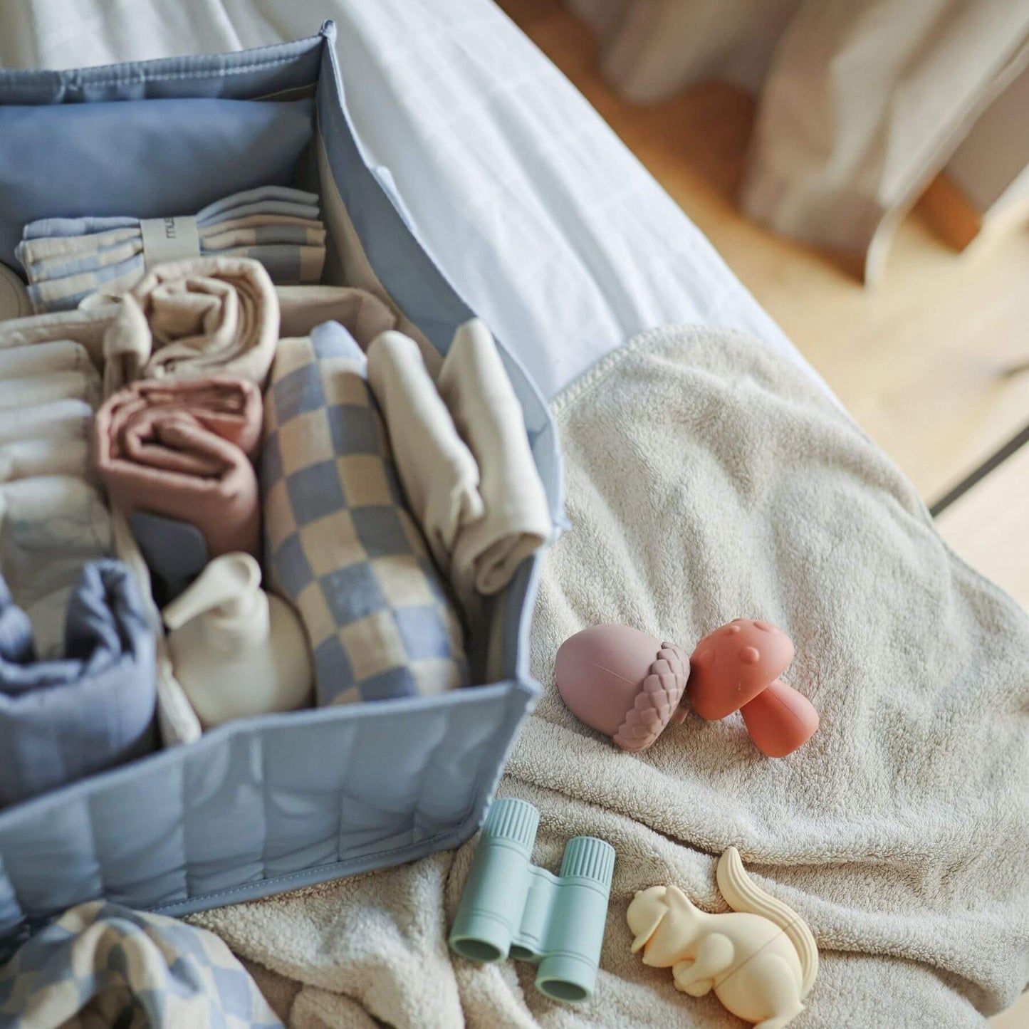 Mushie Diaper Caddy with baby items