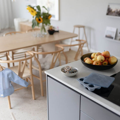 Modern kitchen with a dining area in the background