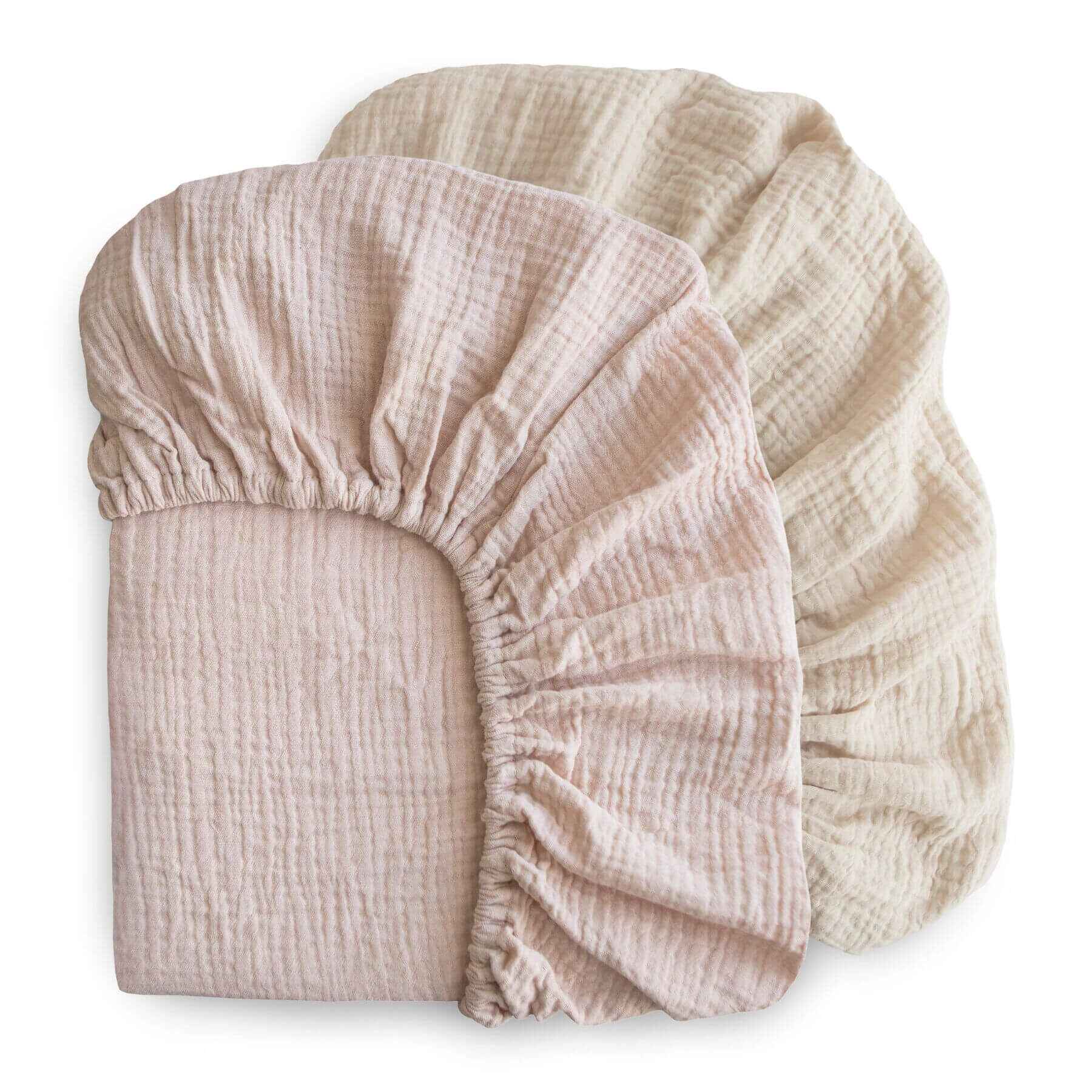 mushie two fabric fitted sheets stacked