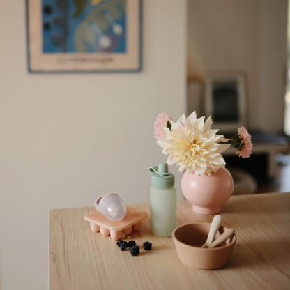 Small decorative items on a wooden surface with a blurred background