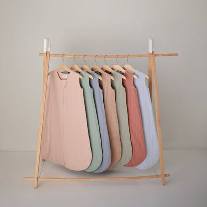 Mushie Organic Cotton Sleep Bags in seven colors, hanging on the shelf