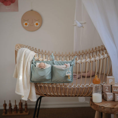 Wooden crib with baby items in a nursery setting