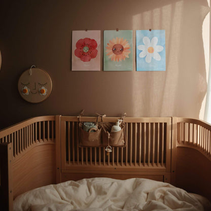 Nursery room with wooden crib and floral wall art