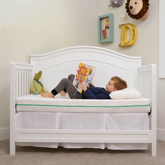 Boy Laying on My First Crib Mattress Flip Version / Crib & Toddler