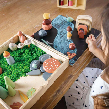 Child playing with Tender Leaf My Forest Floor on a table