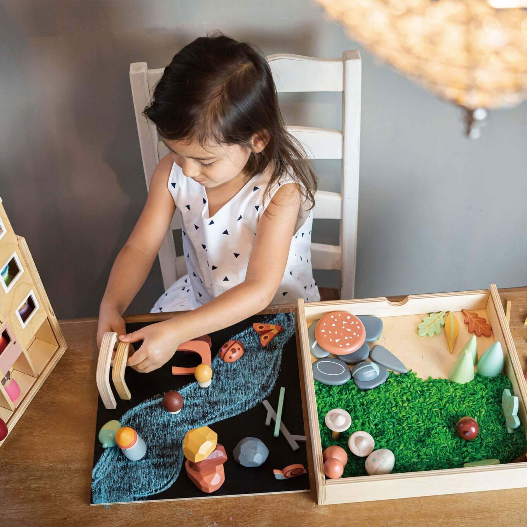 Child playing with Tender Leaf My Forest Floor on a table