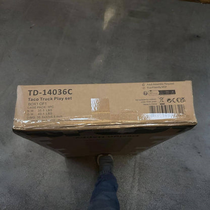 Cardboard box with 'TD-14036C' on a concrete floor