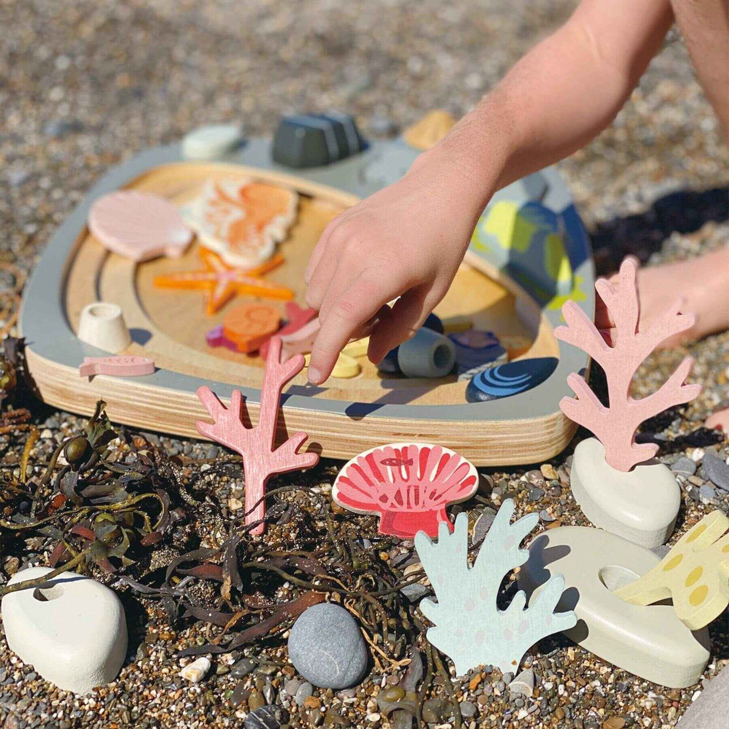 Child playing with Tender Leaf My Little Rock Pool on a beach