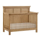 Mystic 4 in 1 Convertible Crib Honey Wood with a white mattress on a white background