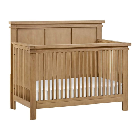 Mystic 4 in 1 Convertible Crib Honey Wood with a white mattress on a white background