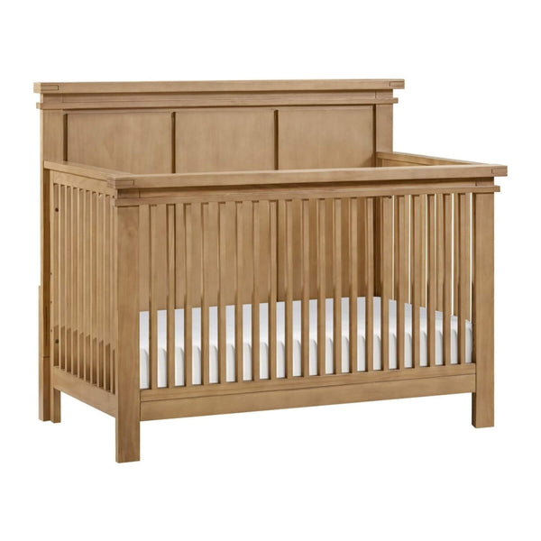 Mystic 4 in 1 Convertible Crib Honey Wood with a white mattress on a white background