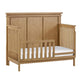 Wooden crib with white mattress on a white background