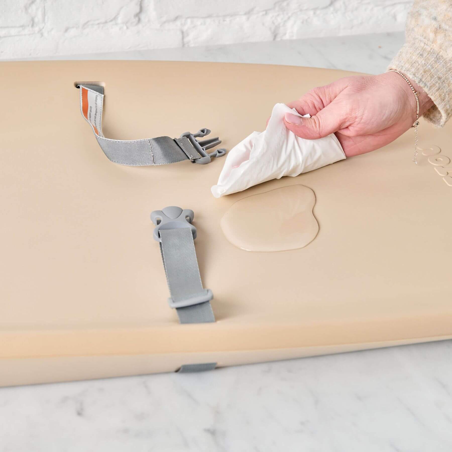 Person wiping water off Nattou Diaper Changing Pad Softy