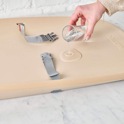 Person Pouring Water on Nattou Diaper Changing Pad Softy Beige