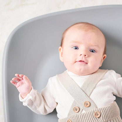 Baby lying on green Nattou Diaper Changing Pad Softy