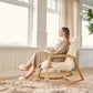 Woman Sitting in Natures Collection Rocking Chair Oak