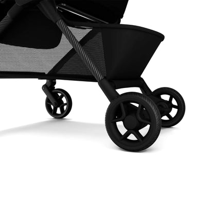 Close-up of a black stroller with wheels on a white background