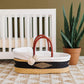 Plum+Sparrow Nightfall African Moses Basket in a nursery setting.