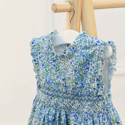 NINA | Girls Blue Floral Cotton Dress on a wooden hanger against a white background