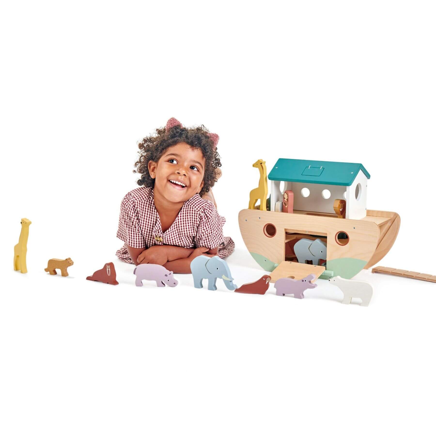 Child playing with Tender Leaf Noah’s Wooden Ark on a white background